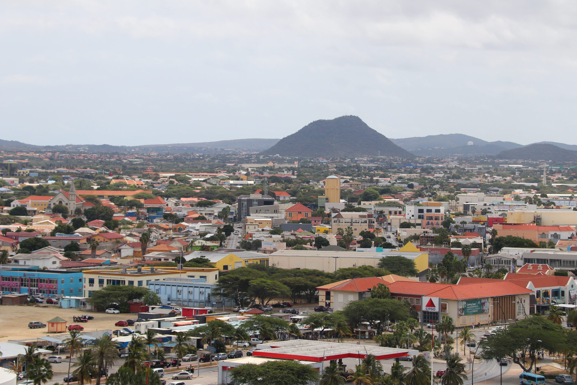 Oranjestad town with painted roofs and the Hooiberg hill behind