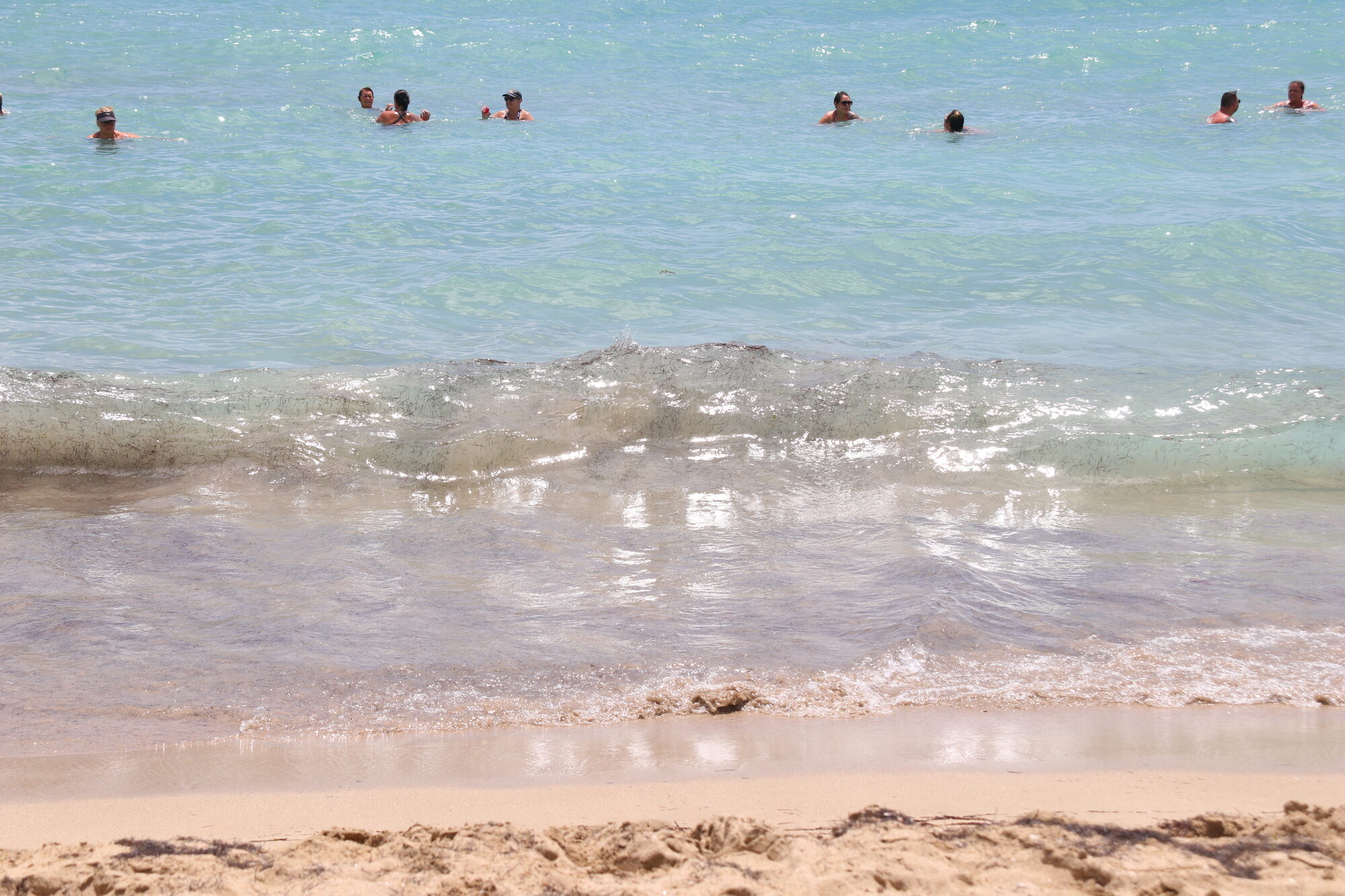 Swimmers floating in warm shallow surf