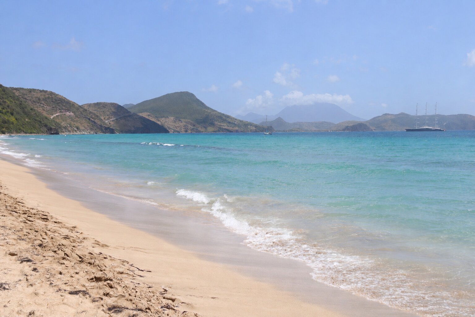 AI-generated image of a beach with green mountains