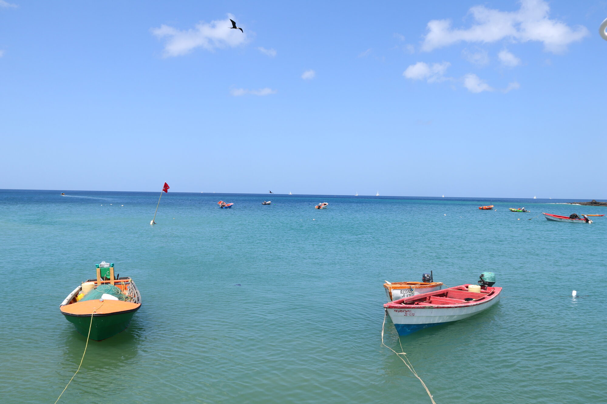 Two fishing boats moored on calm turquoise water