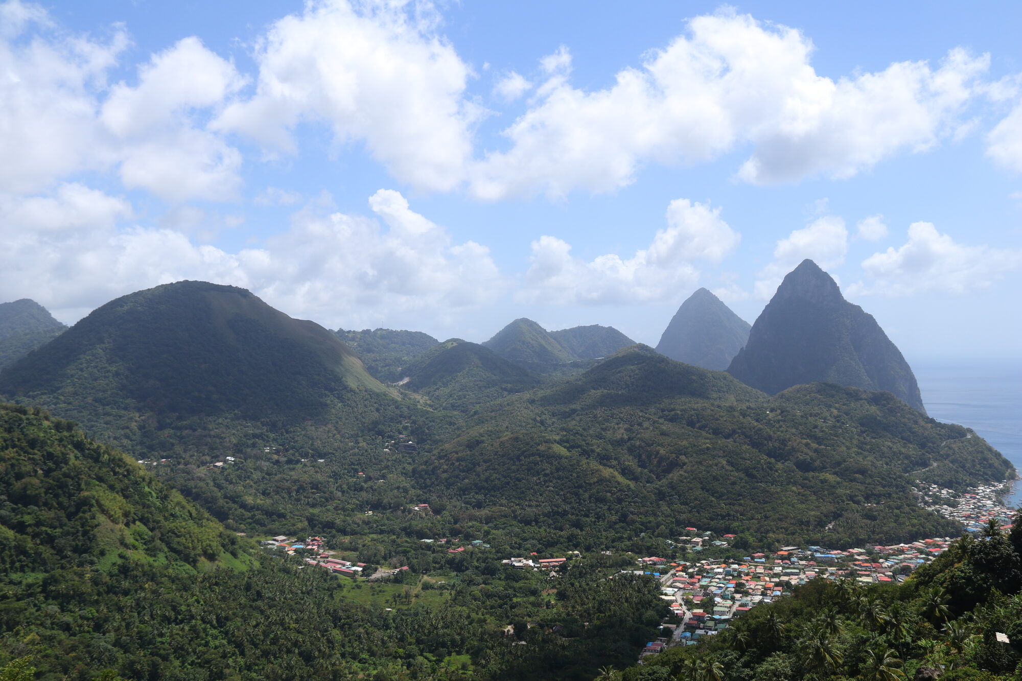 The Pitons rising over the green valley and Soufrière